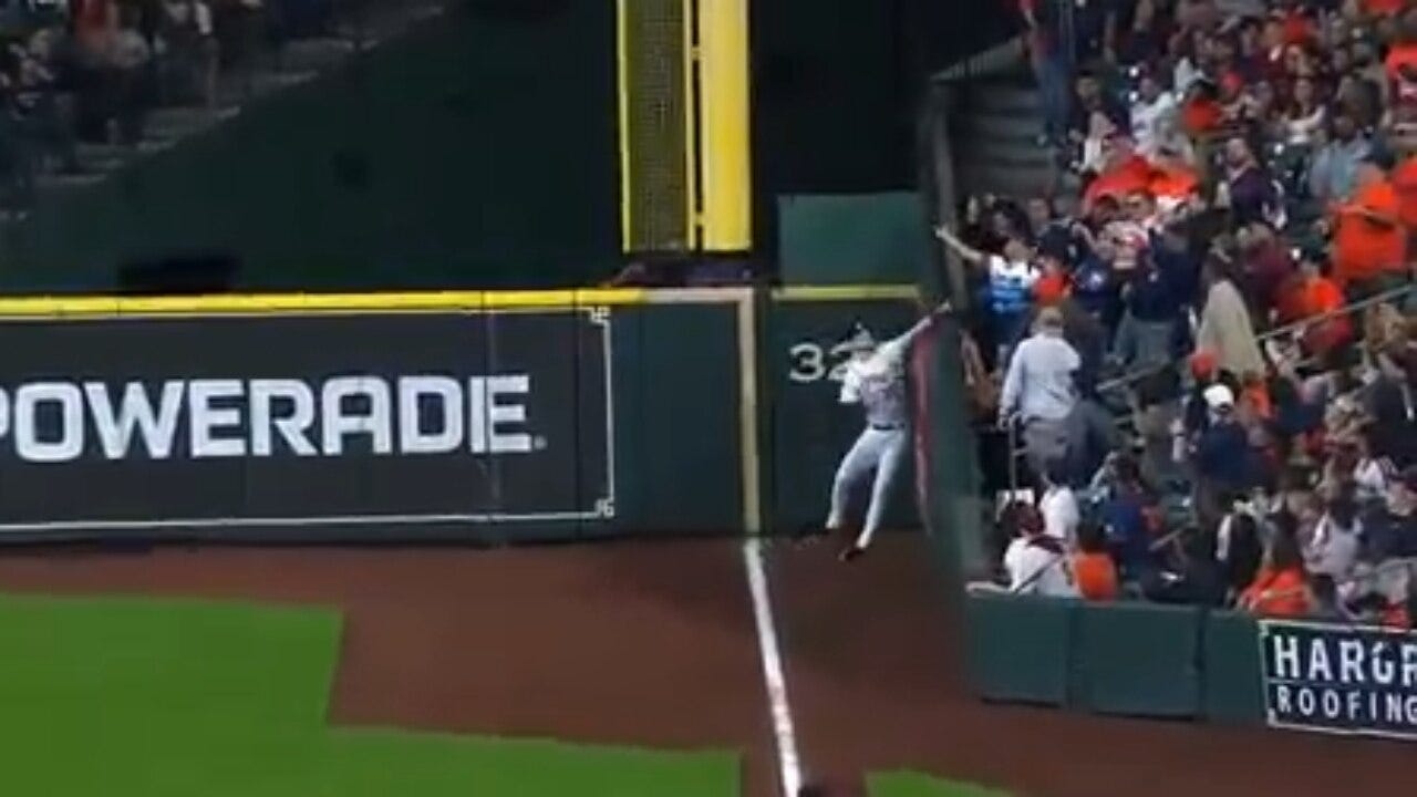 Astros’ Kyle Tucker reaches over the wall to make an impressive grab in foul territory