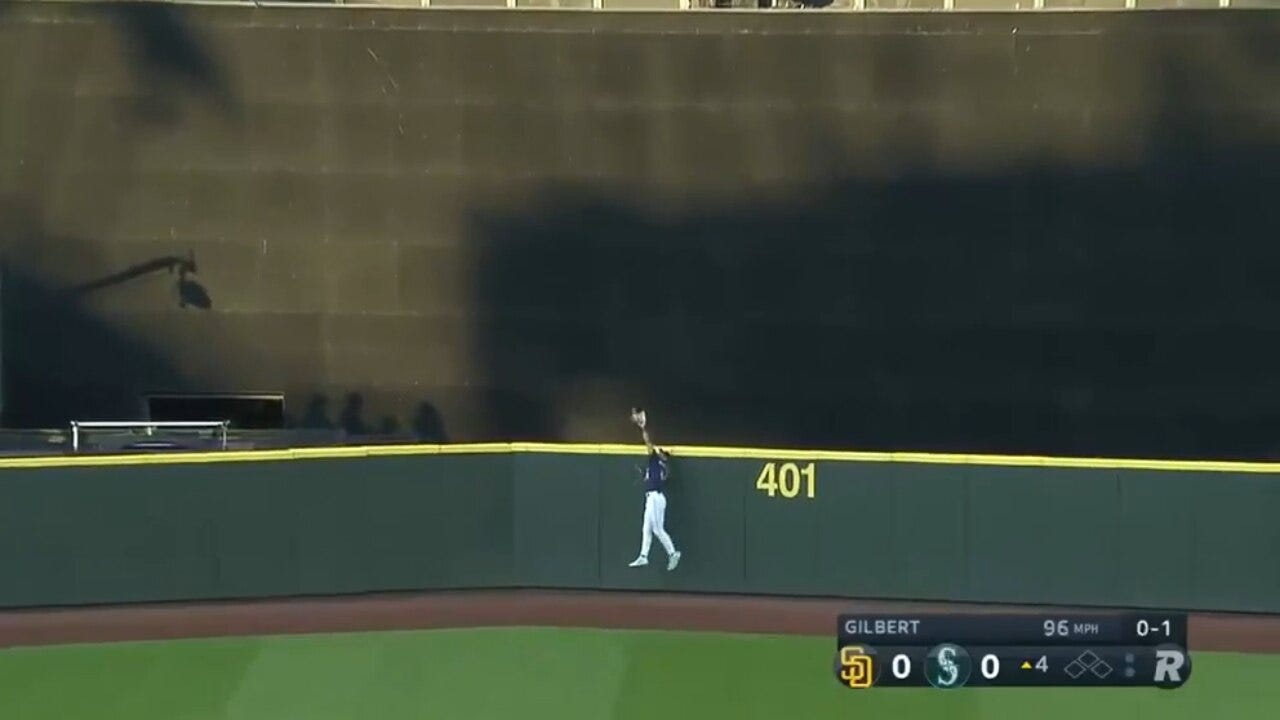 Mariners' Julio Rodríguez makes a leaping catch to ROB Padres' Fernando Tatis Jr. of a home run