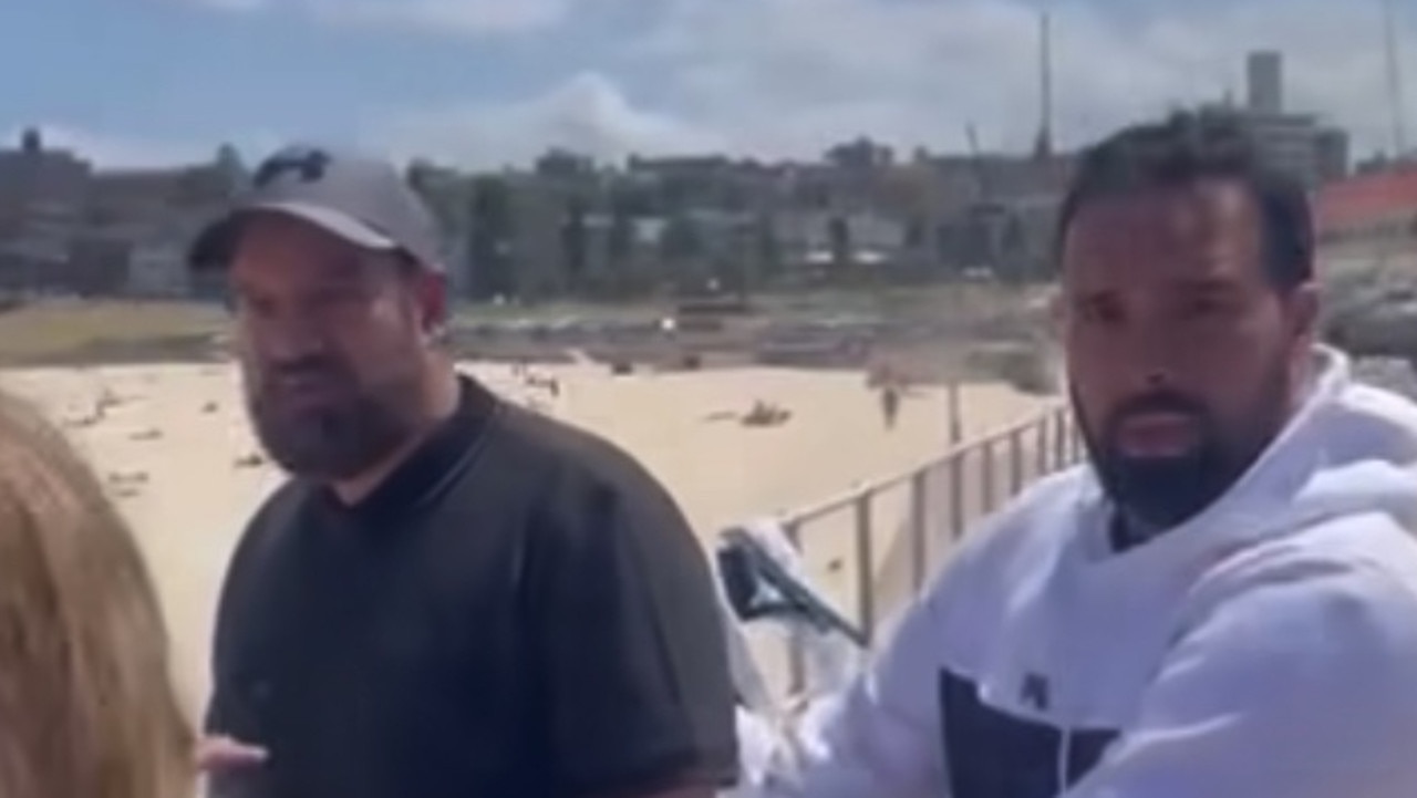 Two men rip down Israel posters at Bondi Beach